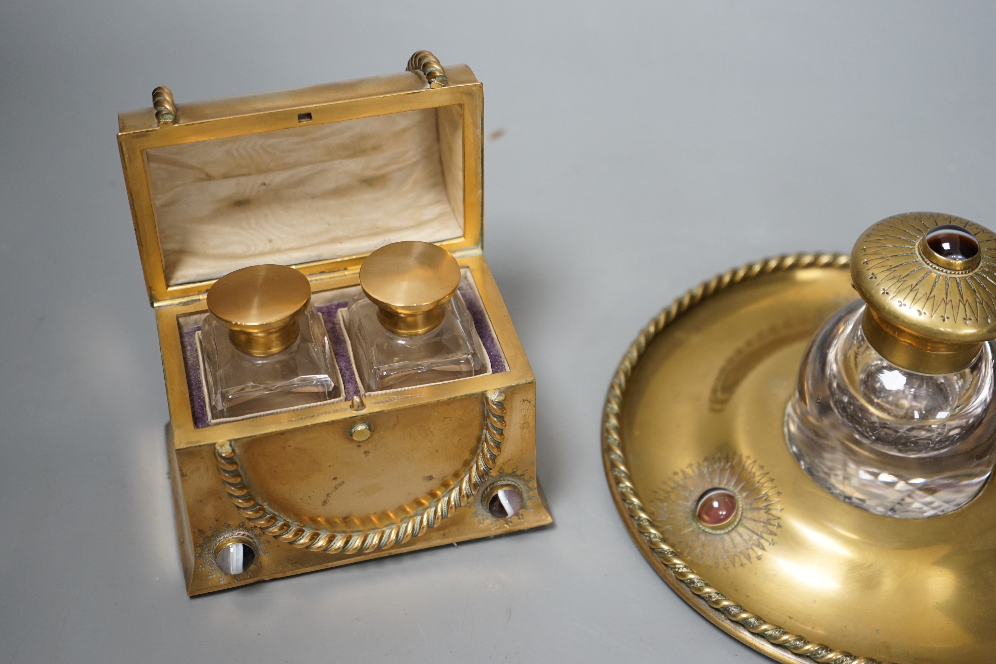 A Victorian agate mounted brass scent bottle casket and similar circular chest inkstand with knotted ribbon relief, 12cm wide